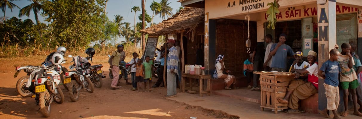 A village street with motorcycles and people